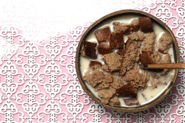 coconut bowl with soy milk and almonds with organic sponge cake Breakfast. flat lay .