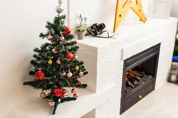 decorated mini christmas tree in the apartment