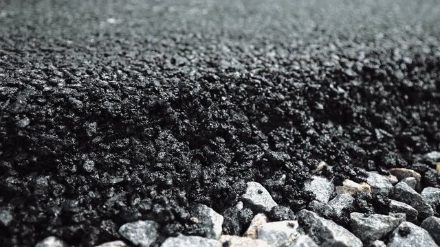 New asphalt on a new road. Perfect Paver Performance. Construction machinery makes a road in a small town, village. Road surface repair, reconstruction