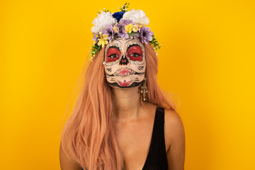 Pleasant looking young female, keeps lips as going to kiss someone, has glad expression, grimace face. Standing outdoors. Beauty concept.