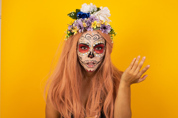 What the hell are you talking about, nonsense. Studio shot of frustrated female wearing halloween make up gesturing with raised palm, frowning, being displeased and confused with dumb question-