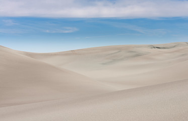 Fototapeta na wymiar Sand dunes against blue sky.