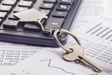 Real estate, keychain with house symbol. Calculator with finance blank.