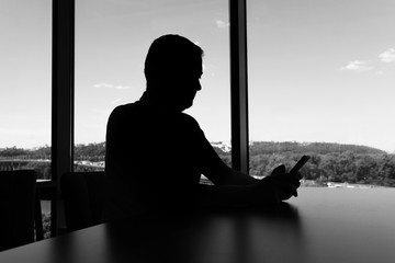 Black and white portrait businessman using smartphone