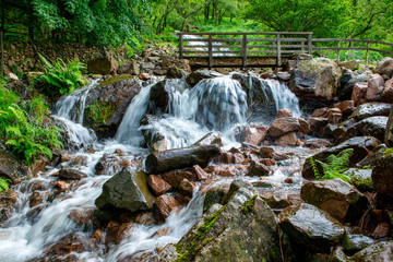 A waterfall on the footpath around Buttermere lake  in the English Lake District, Cumbria, England. Popular with visitors due to its scenery, Buttermere means 'the lake by the dairy pastures'