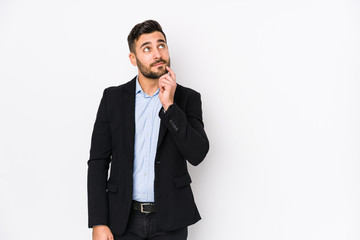 Young caucasian business man against a white background isolated looking sideways with doubtful and skeptical expression. - obrazy, fototapety, plakaty