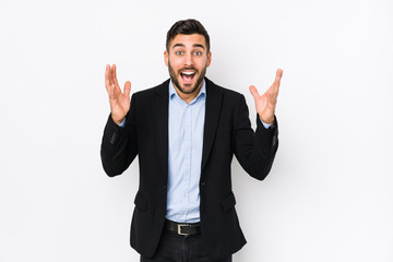 Young caucasian business man against a white background isolated receiving a pleasant surprise,...