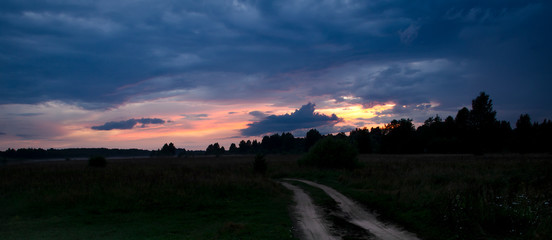 Sunset in the riverbank and village road.