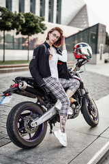 Fototapeta na wymiar Cute and beautiful girl on a stylish sport motorcycle