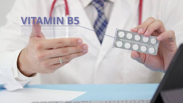 Medical doctor talks about Vitamin b5 tablets in his office. Telemedicine session with a patient