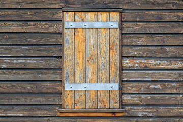 wall of wooden boards with a closed window