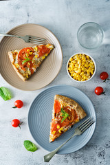 Onion tomato cream cheese whole grain galette in a plate