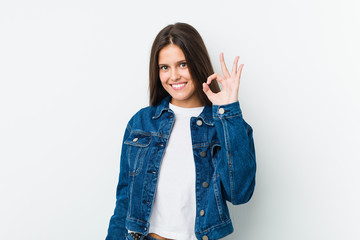 Young cute woman cheerful and confident showing ok gesture.