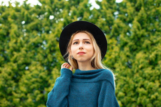 Beautiful Caucasian White Girl Portrait Looking Side Ways In Park Outdoor Environment Space With Unfocused Green Foliage Background Scenic