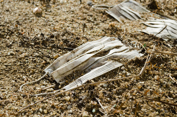 white disposable masks thrown on the ground