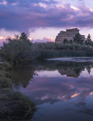 A natural rock formation at the base of the rocky mountains. The colorful evening glow is enhanced...