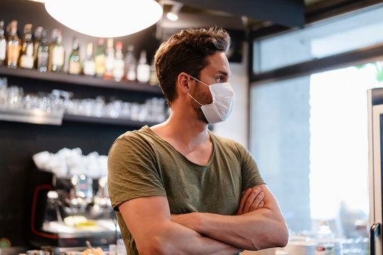 Portrait of restaurant manager with mask looking sideways