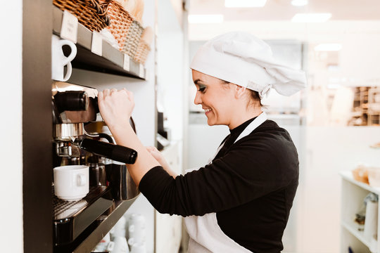 Happy baker preparing coffee at bakery