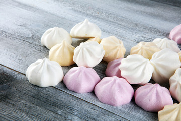 Meringue. Crispy white and pink twisted meringue. Concept love of sweet on table