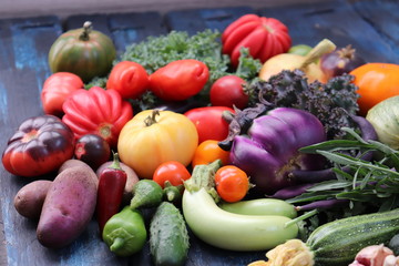 Multicolored vegetables on a dark wooden background, selective focus.