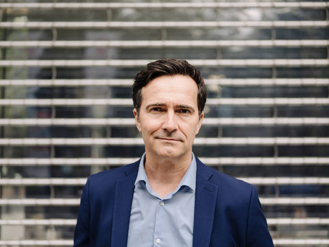 Portrait of a confident mature businessman at a facade