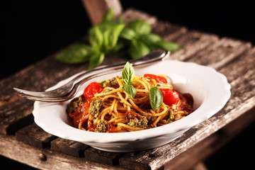 Plate of delicious spaghetti Bolognaise or Bolognese with savory minced beef and tomato sauce garnished with parmesan