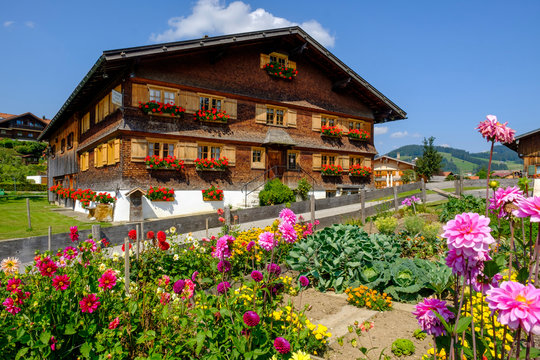 Germany, Bavaria, Swabia, Allgau, Oberstaufen, Flowers in garden and wooden rural house