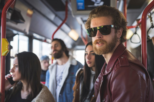 Bearded young man with friends traveling in bus