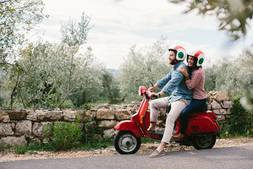Couple exploring Tuscanyon Vespa, Italy