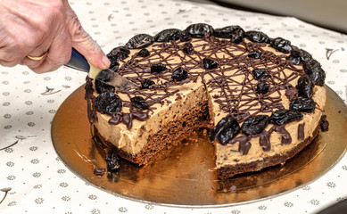Homemade cake with chocolate cream and prunes.