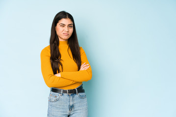 Young indian woman isolated on blue background unhappy looking in camera with sarcastic expression.