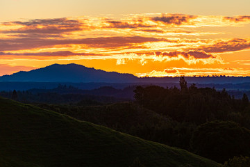 Sun setting over farmland in Rotorua, New Zealand 