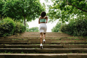 Rear view of female jogger on steps
