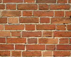 Weathered brickwall of old dark brown and red brick wall