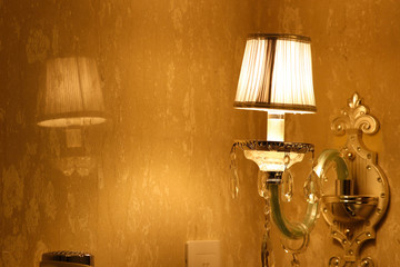 Designer Night Lamp Fixed On Wall Of Bedroom Or Hotel And Golden Yellow Glowing Light At Night
