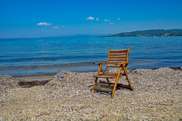 Wooden summer chair on the beach