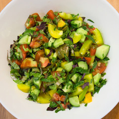 Overhead view of a plate of healthy vegetable salad on white plate