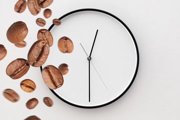  coffee beans fall on the white clock. coffee time