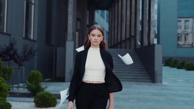 Happy woman finished the project, throwing papers, freedom after work, success in business. Businesswoman smiles and laughs, winner won the competition, emotions from victory. Student defended thesis