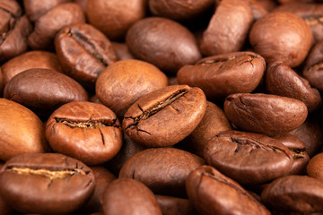 Roasted Coffee beans background close up. International coffee day concept. Macro photography. Texture for design.