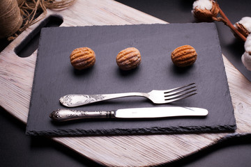 Tasty sweets on chopping board and wooden table. Autumn season food photo