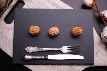 Tasty sweets on chopping board and wooden table. Autumn season food photo