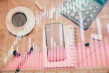 Multi exposure of forex graph hologram over desktop with phone. Top view. Mobile trade platform...