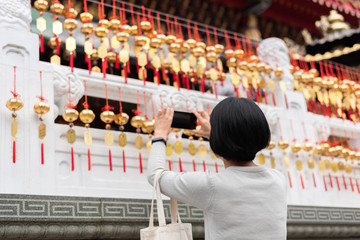woman take a picture at the golden bells