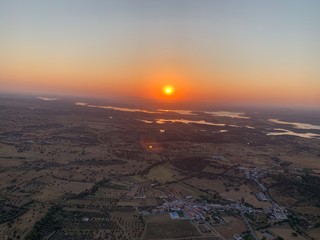 Hot air balloon flight at sunrise, Aerial View over the great Alqueva lake, in Alentejo, Portugal