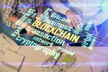 Double exposure of man and woman working together and crypto theme hologram drawing. Computer...