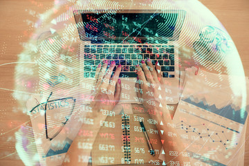 Double exposure of woman hands working on computer and financial theme hologram drawing. Top View. Business concept.