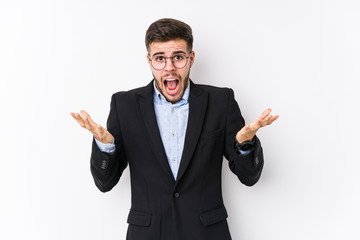 Young caucasian business man posing in a white background isolated Young caucasian business man celebrating a victory or success, he is surprised and shocked.