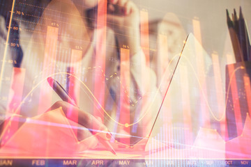 Double exposure of woman hands typing on computer and financial graph hologram drawing. Stock market analysis concept.