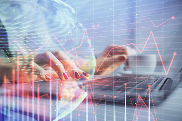 Multi exposure of woman hands typing on computer and financial graph hologram drawing. Stock market analysis concept.